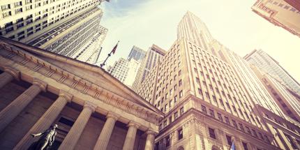 Tall Buildings with American Flag and Blue Sky