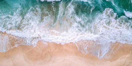 Waves crashing on sandy shore