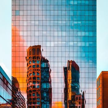 Tall glass building with orange reflection